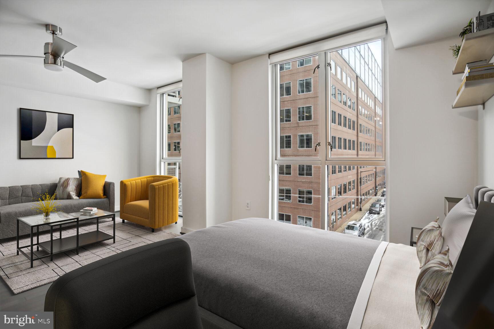 1025 First Street Southeast, Unit 507 Washington, DC 20003 - Photo 5 of 18 a bedroom with a bed a couch and a window
