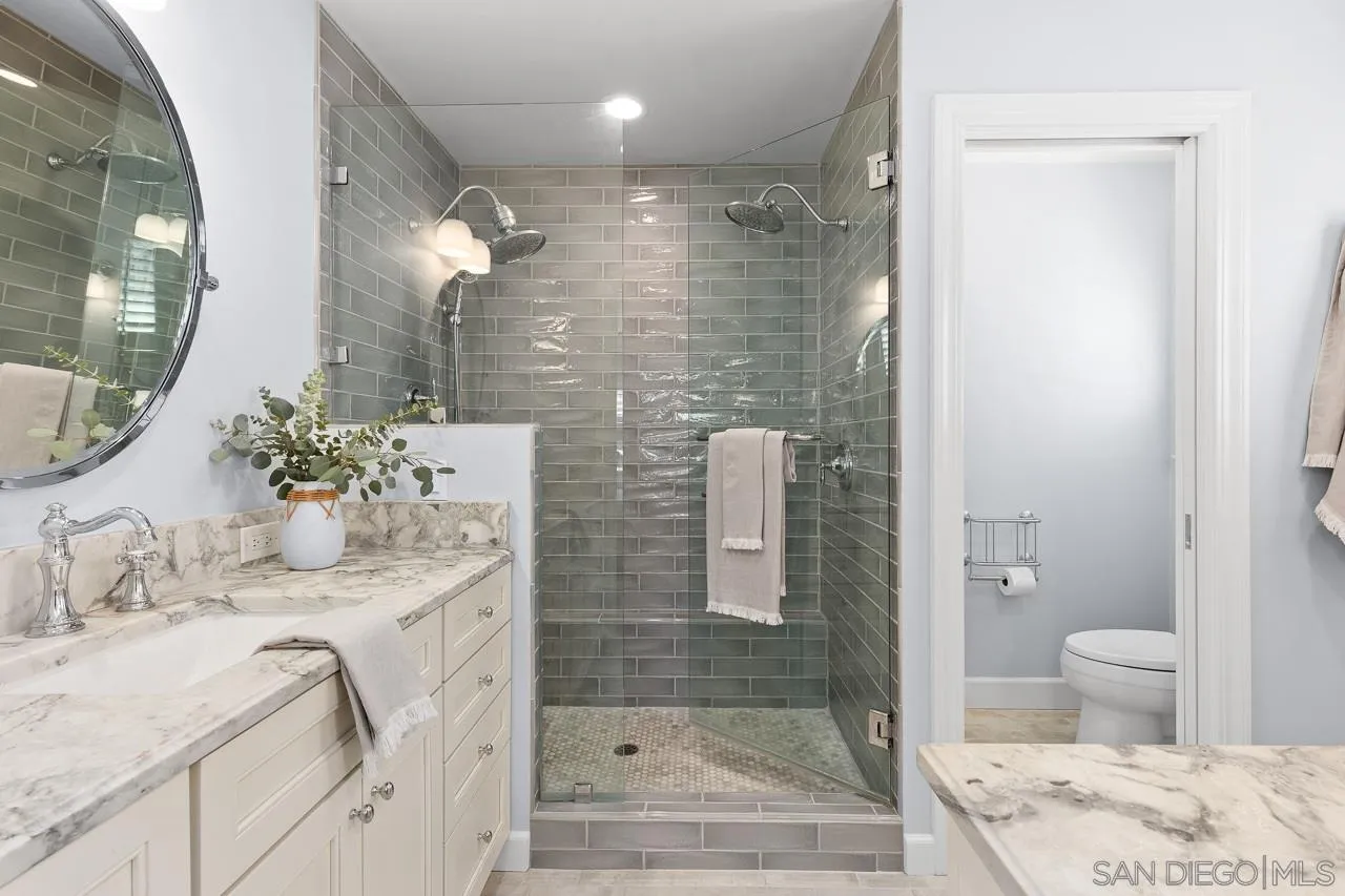 910 Edwina Way Cardiff, CA 92007 - Photo 14 of 30 a bathroom with a granite countertop sink a toilet and shower