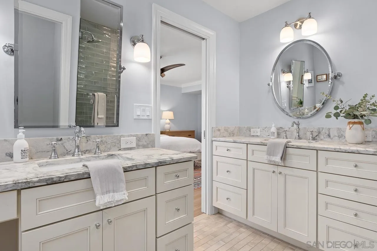 910 Edwina Way Cardiff, CA 92007 - Photo 15 of 30 a bathroom with a double vanity sink and a mirror