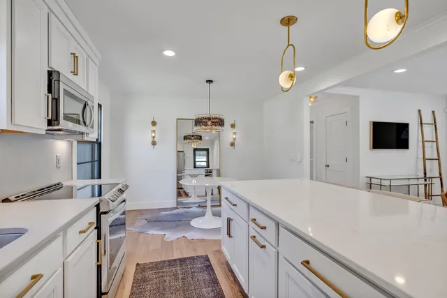 a kitchen with a sink appliances and a counter top space