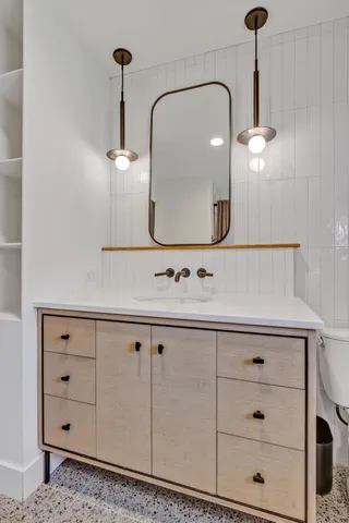 a bathroom with a sink vanity and a mirror