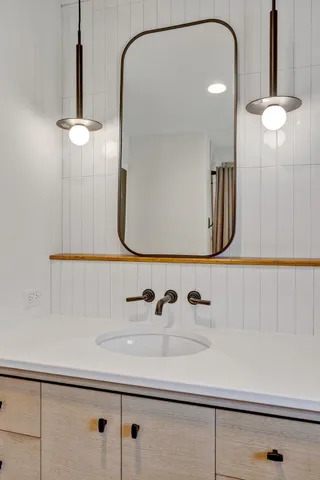 a bathroom with a sink and a mirror