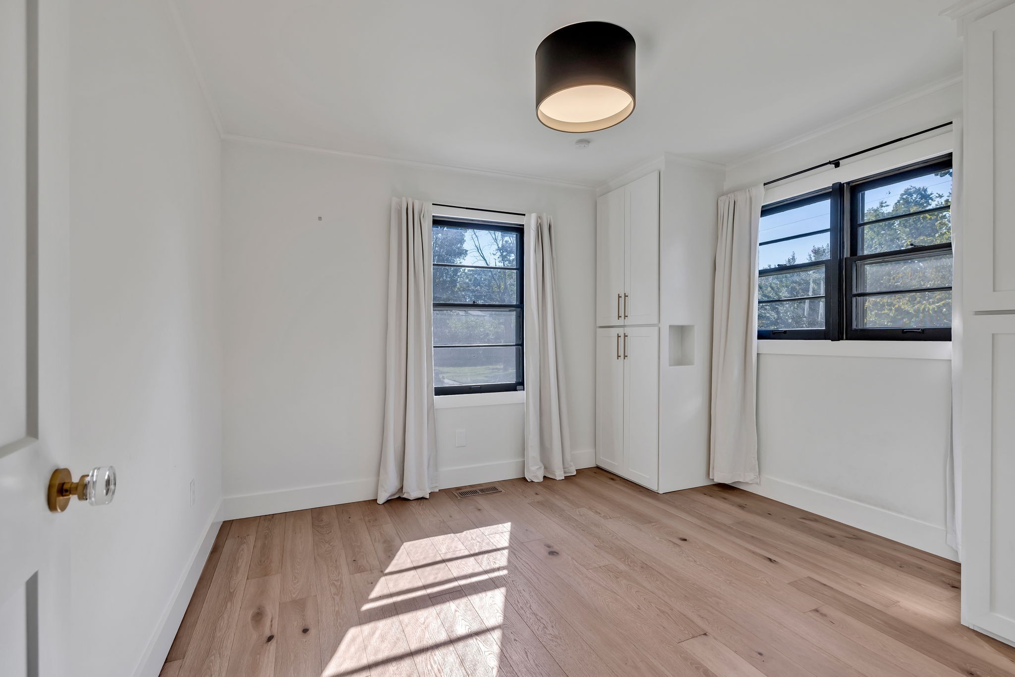 313 James Avenue Franklin, TN 37064 - Photo 43 of 49 an empty room with wooden floor and windows