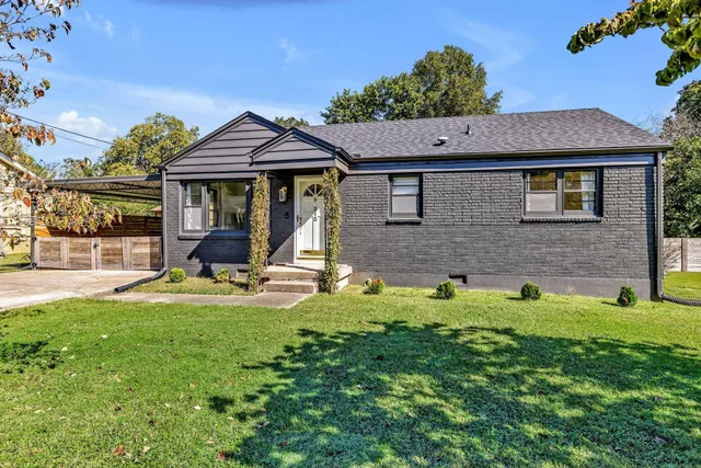 a view of an house with backyard space and sitting area