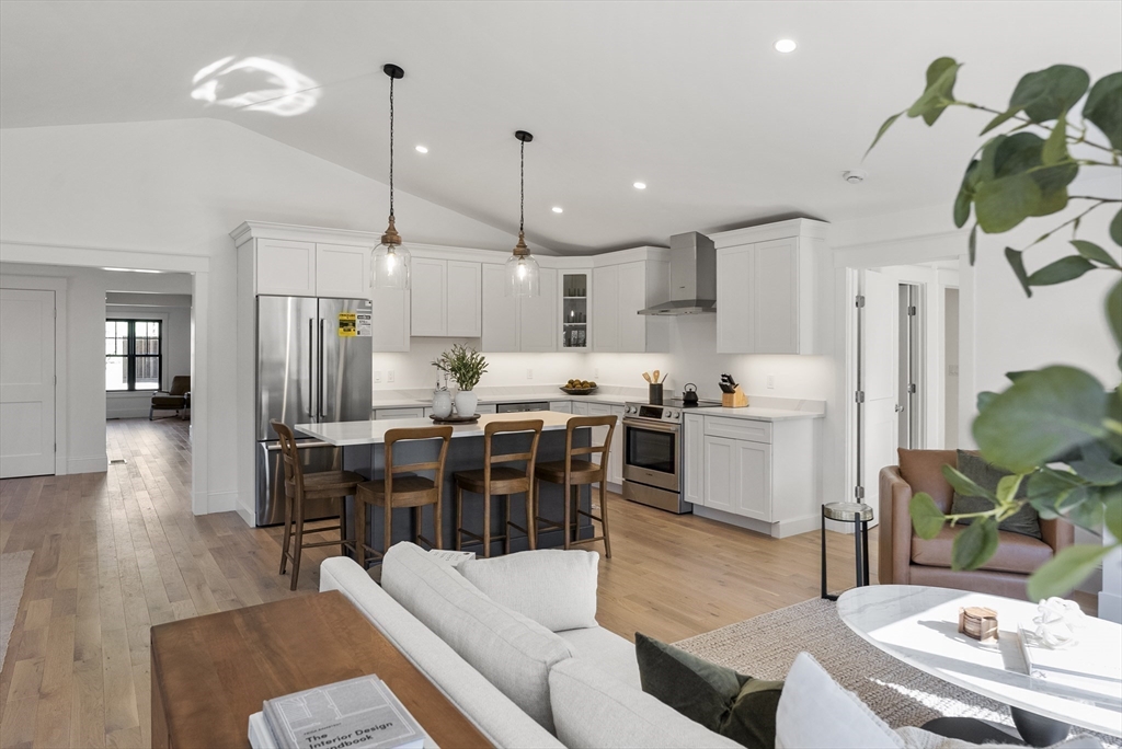 46 Sandwich Road, Unit 41 Plymouth, MA 02360 - Photo 14 of 42 a living room with stainless steel appliances kitchen island granite countertop furniture wooden floor and a kitchen view