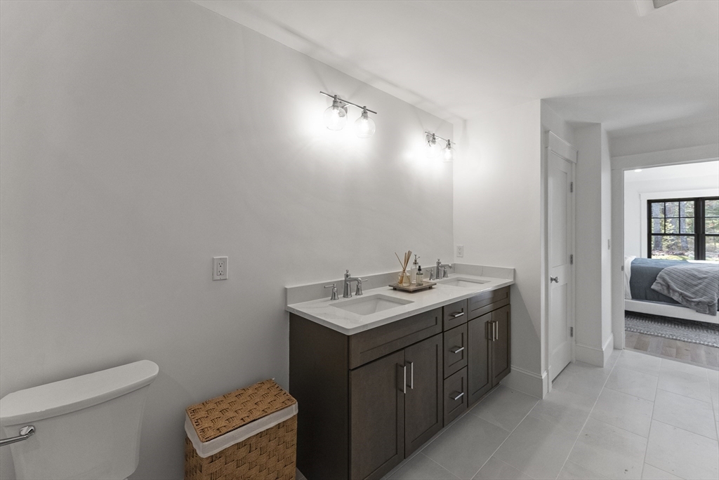 46 Sandwich Road, Unit 41 Plymouth, MA 02360 - Photo 26 of 42 a bathroom with a sink a toilet and mirror