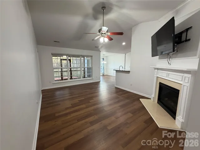 a view of a livingroom with an empty space and a fireplace