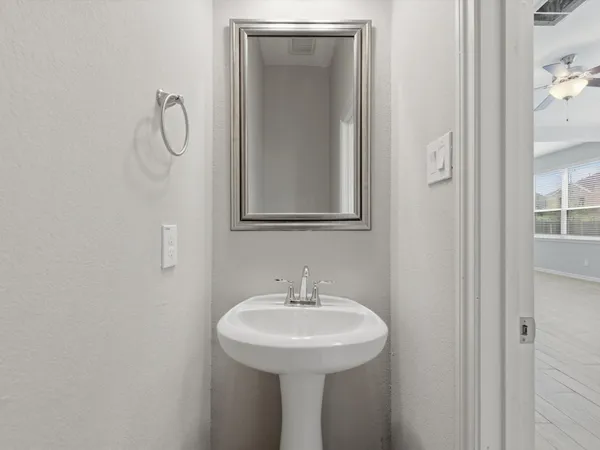 a white bath tub sitting next to a shower