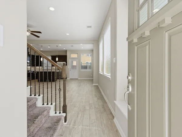 a large kitchen with stainless steel appliances granite countertop a stove a refrigerator a sink dishwasher and a oven with wooden floor