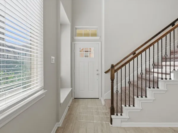 a kitchen with stainless steel appliances granite countertop a sink a stove a refrigerator and a oven with wooden floor