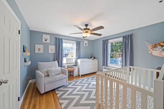 a living room with furniture and a table with wooden floor