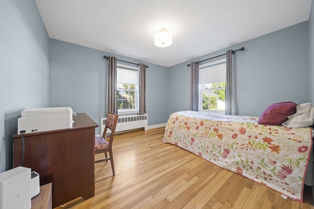 7 Rainbow Terrace Danvers, MA 01923 - Photo 19 of 33 a bedroom with a bed and wooden floor