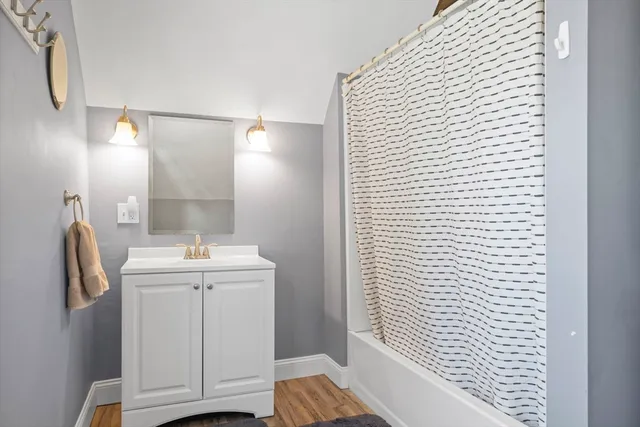 a bathroom with a sink a toilet and mirror