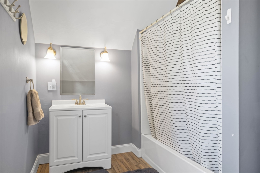 7 Rainbow Terrace Danvers, MA 01923 - Photo 25 of 33 a bathroom with a sink a toilet and mirror