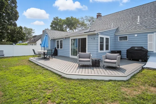 a view of a house with swimming pool and furniture
