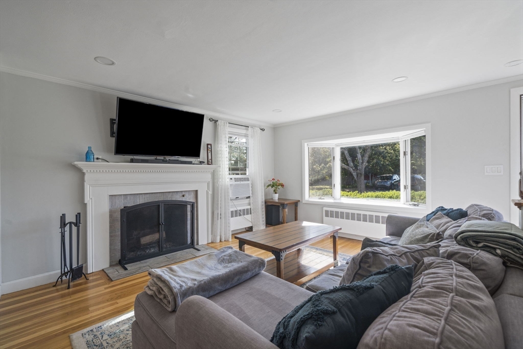 7 Rainbow Terrace Danvers, MA 01923 - Photo 3 of 33 a living room with furniture a fireplace and a flat screen tv