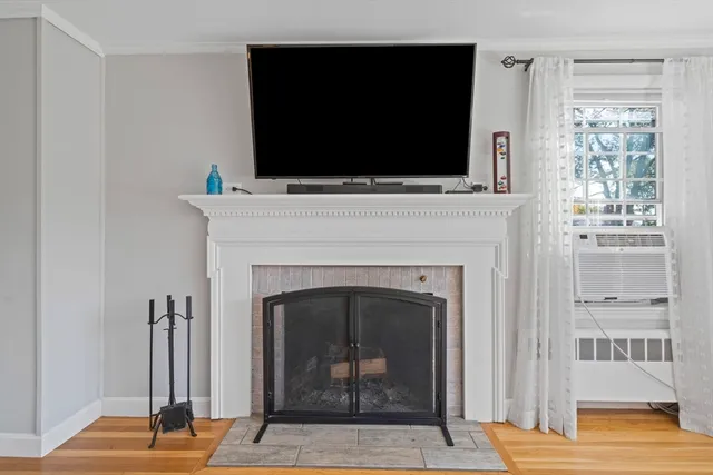a living room with a fireplace and a flat screen tv
