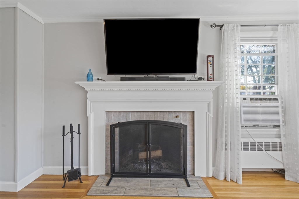 7 Rainbow Terrace Danvers, MA 01923 - Photo 6 of 33 a living room with a fireplace and a flat screen tv