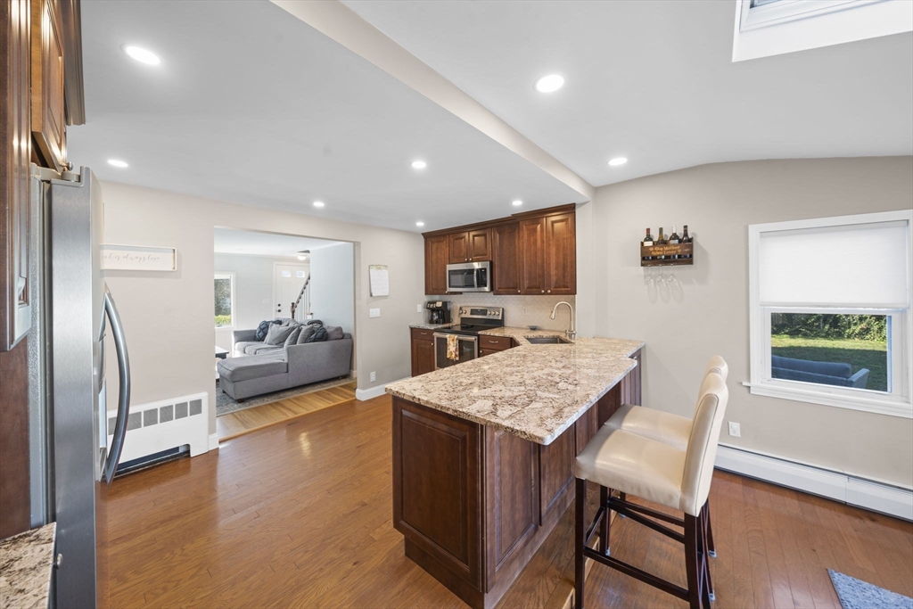 7 Rainbow Terrace Danvers, MA 01923 - Photo 8 of 33 a large kitchen with a table and chairs