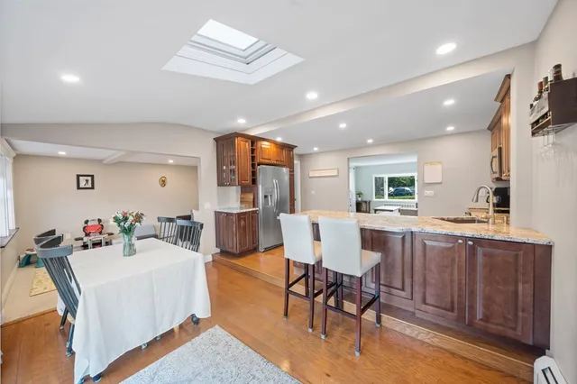 a living room with furniture a dining table and kitchen view
