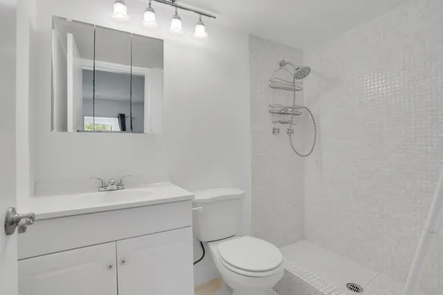 a bathroom with a sink toilet and shower