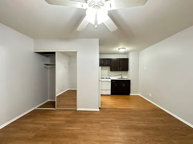 a view of a kitchen with a microwave and a ceiling fan