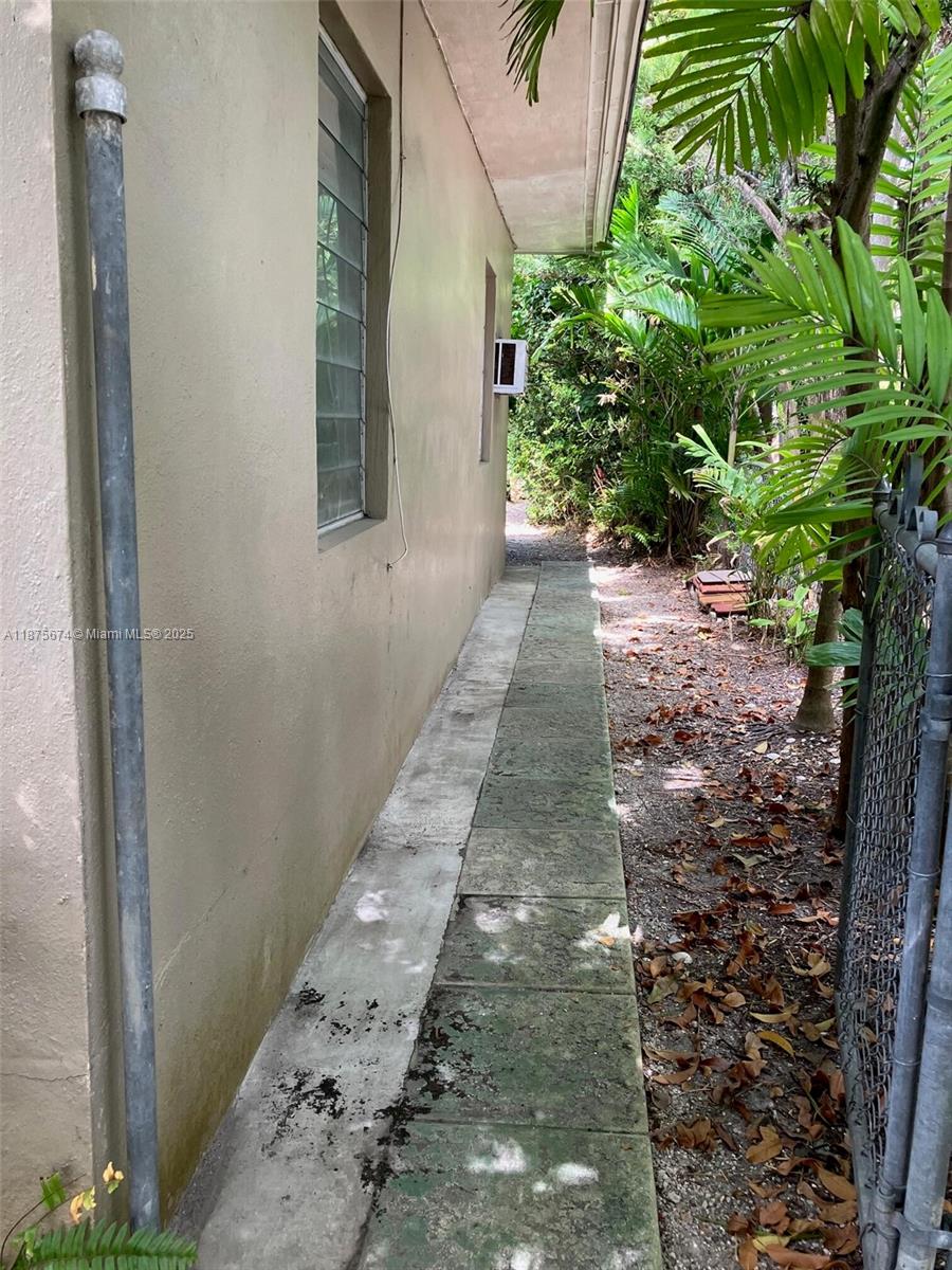 737 Woodcrest Road Key Biscayne, FL 33149 - Photo 6 of 6 a view of a pathway both side of house