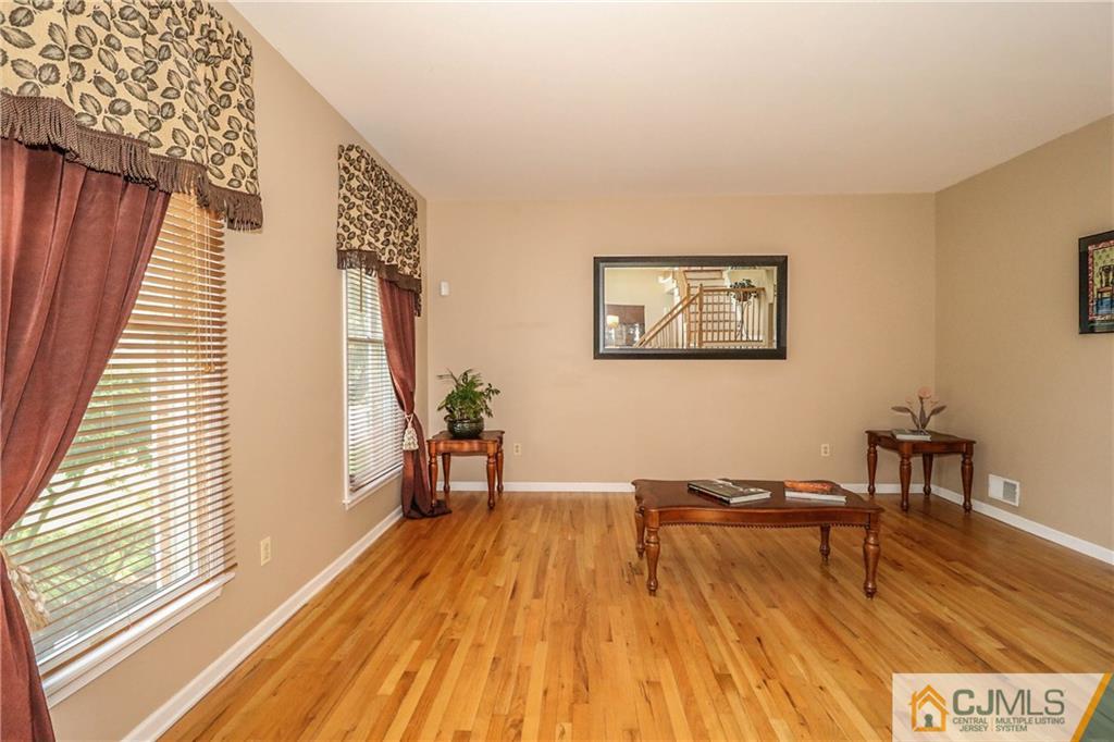 1115 New Dover Road Edison, NJ 08820 - Photo 3 of 25 a view of a living room filled with furniture and wooden floor