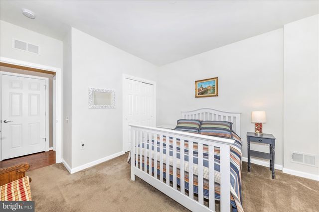 a open kitchen with stainless steel appliances granite countertop a stove top oven a sink dishwasher a dining table and chairs with wooden floor