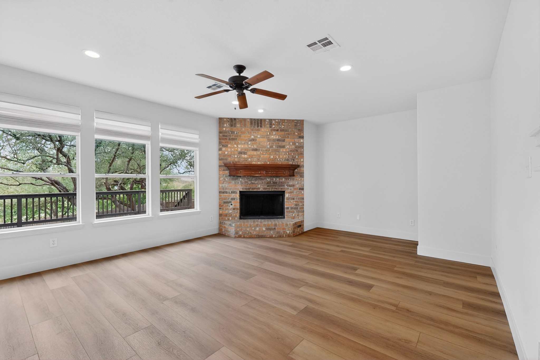 8617 Cobblestone Austin, TX 78735 - Photo 4 of 39 a view of an empty room with a fireplace and a window