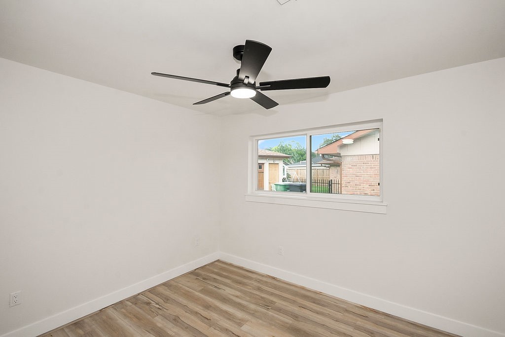 6106 Rutherglenn Drive Houston, TX 77096 - Photo 35 of 41 Another view of the additional bedroom with updated flooring and modern ceiling fan.