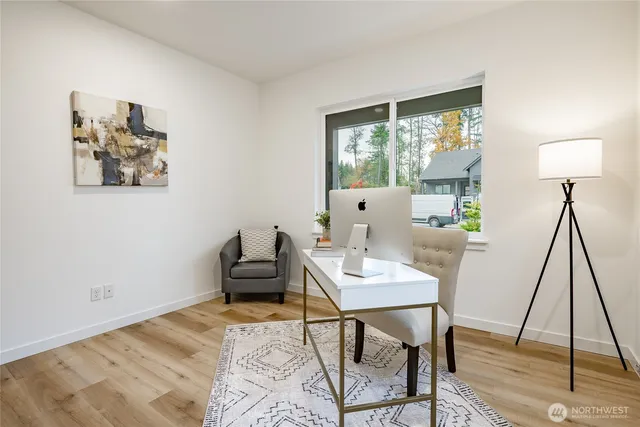a view of a workspace with furniture and a window