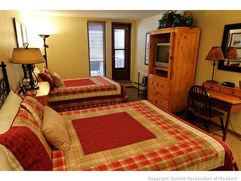 800 Copper Road, Unit 179 Copper Mountain, CO 80443 - Photo 12 of 23 a bedroom with a bed and wooden floor