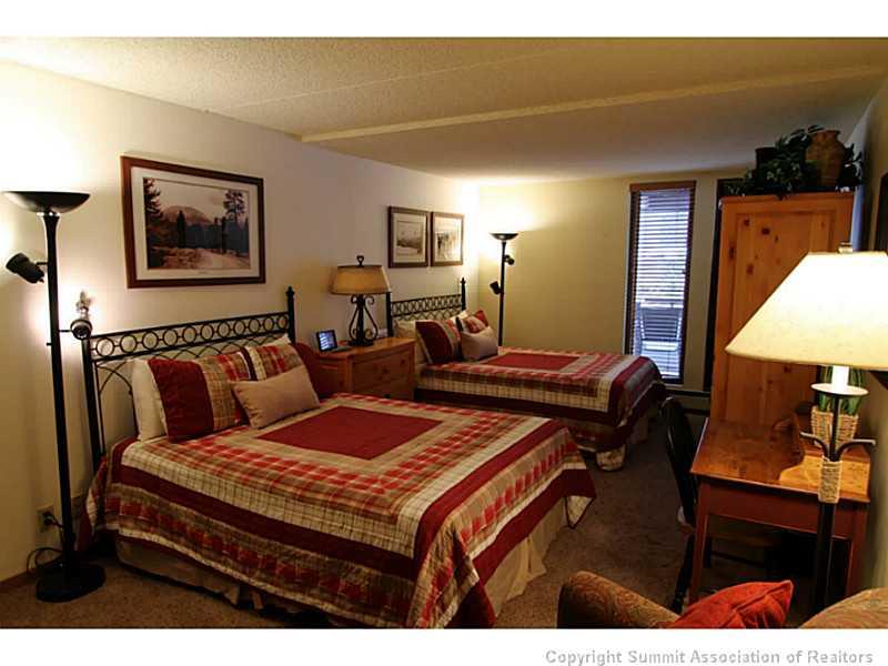 800 Copper Road, Unit 179 Copper Mountain, CO 80443 - Photo 14 of 23 a bedroom with a bed and dresser with mirror