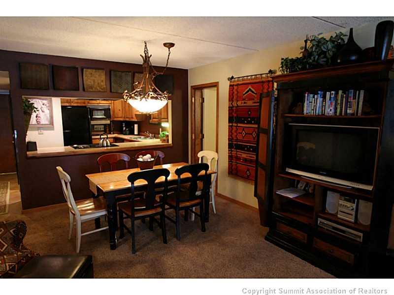 800 Copper Road, Unit 179 Copper Mountain, CO 80443 - Photo 4 of 23 a view of a dining room with furniture and chandelier