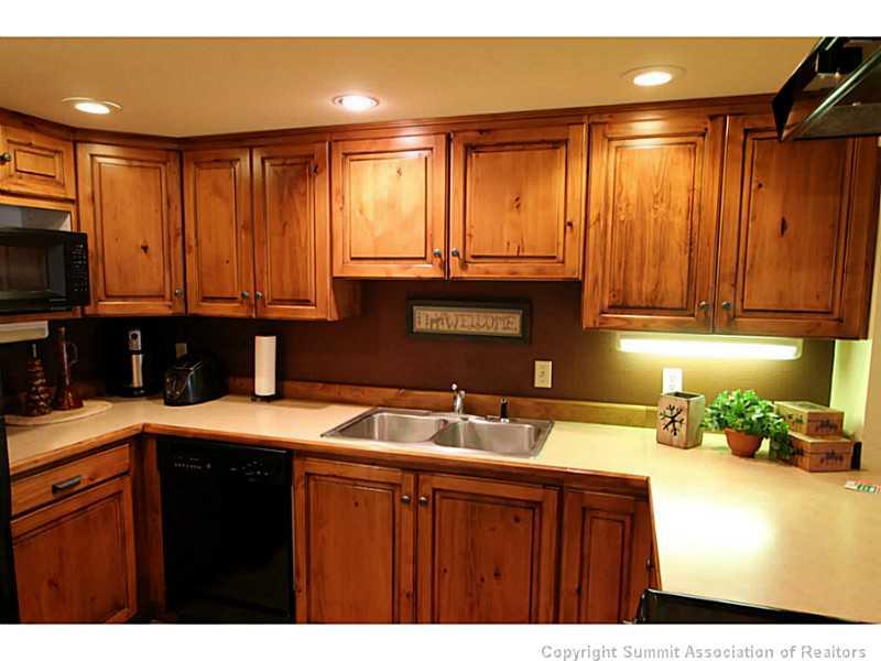 800 Copper Road, Unit 179 Copper Mountain, CO 80443 - Photo 6 of 23 a kitchen with stainless steel appliances wooden cabinets a sink and a granite counter top