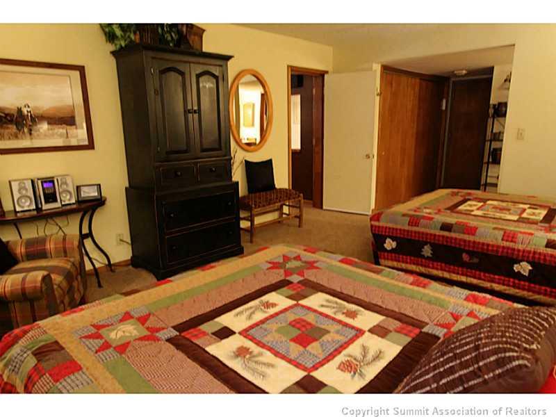 800 Copper Road, Unit 179 Copper Mountain, CO 80443 - Photo 10 of 23 a bedroom with two beds and painting on the wall