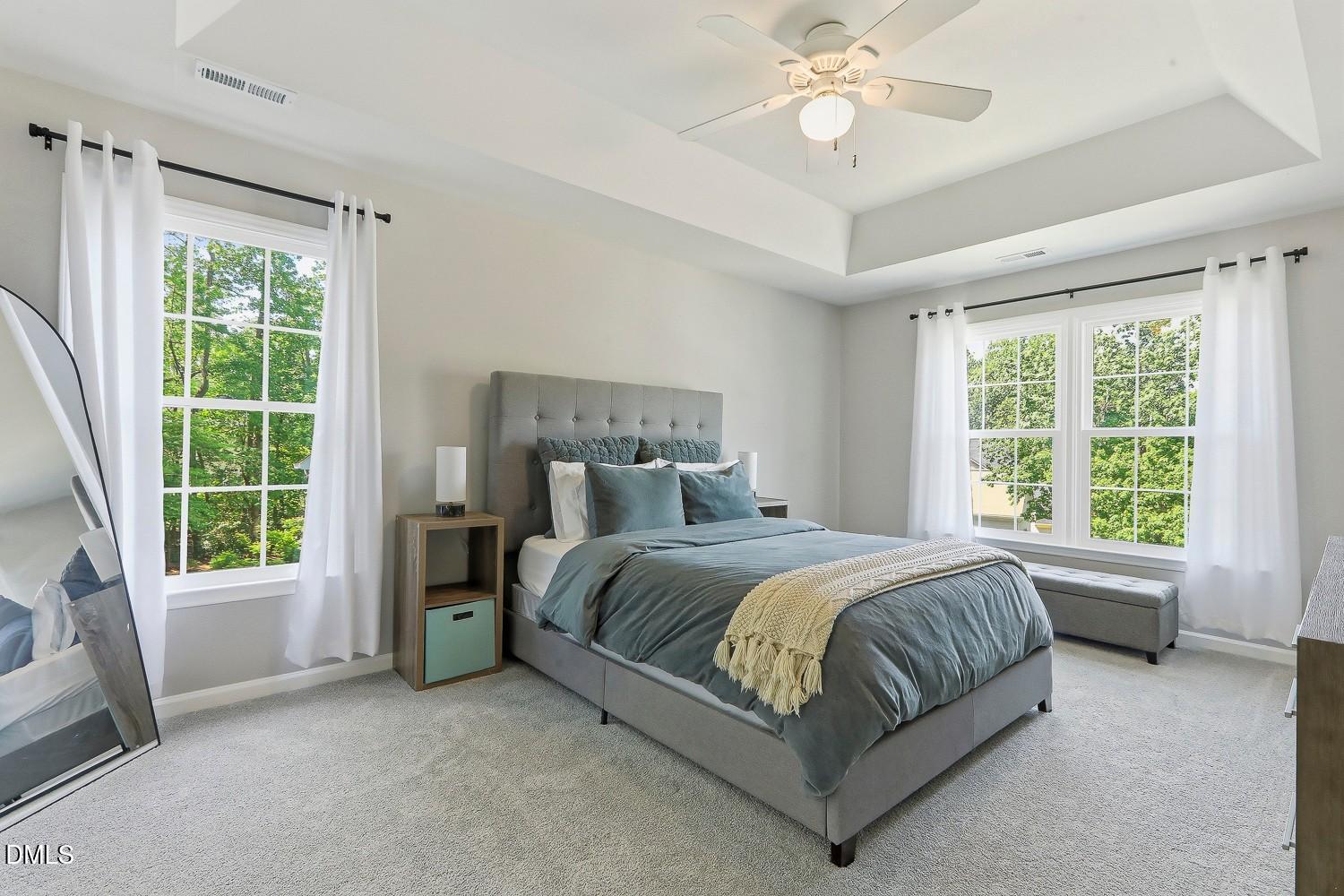 4001 Batiste Road Raleigh, NC 27613 - Photo 27 of 63 a spacious bedroom with a bed and a chandelier