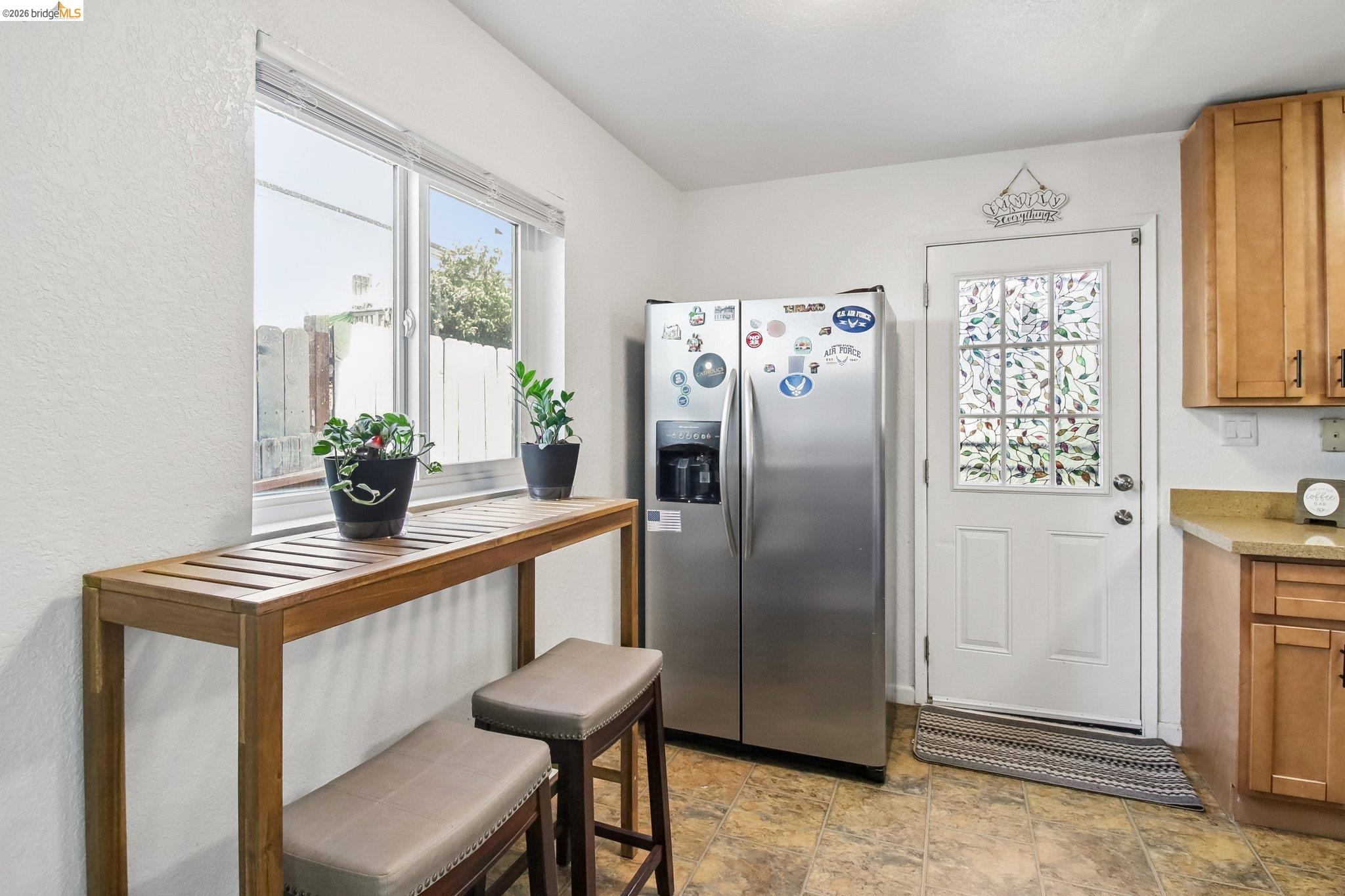 874 Pine Street Oakland, CA 94607 - Photo 8 of 39 Kitchen area featuring a window with natural light, light-toned cabinetry, and granite-look countertops