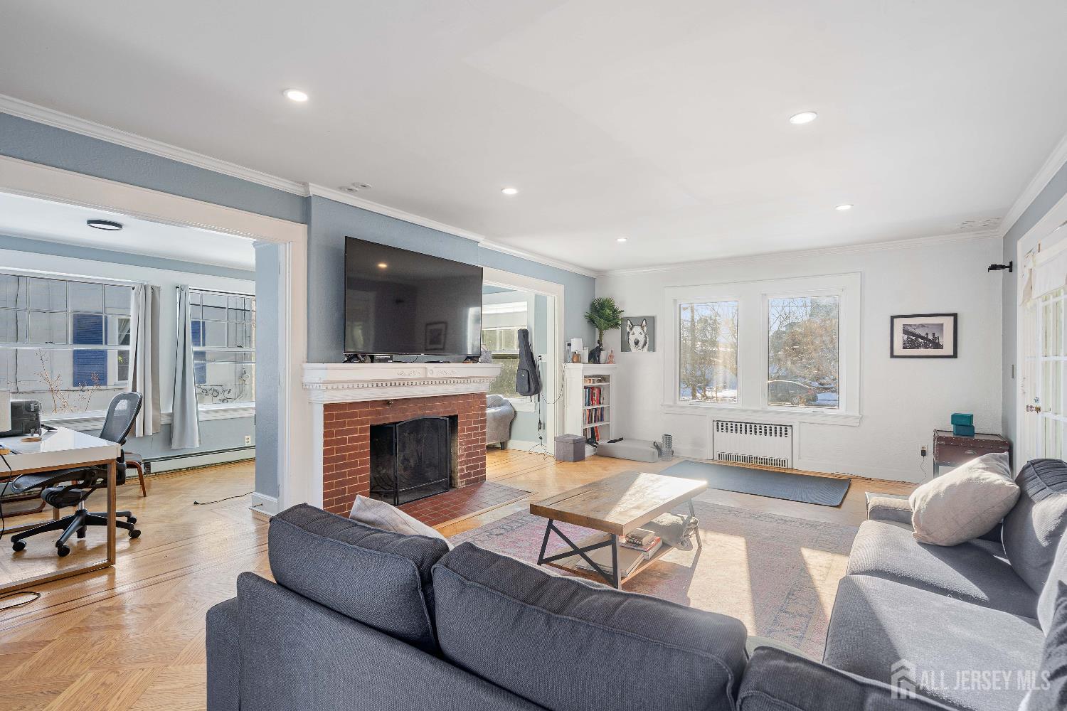 631 Union Avenue Elizabeth, NJ 07208 - Photo 16 of 30 a living room with furniture a fireplace and a flat screen tv