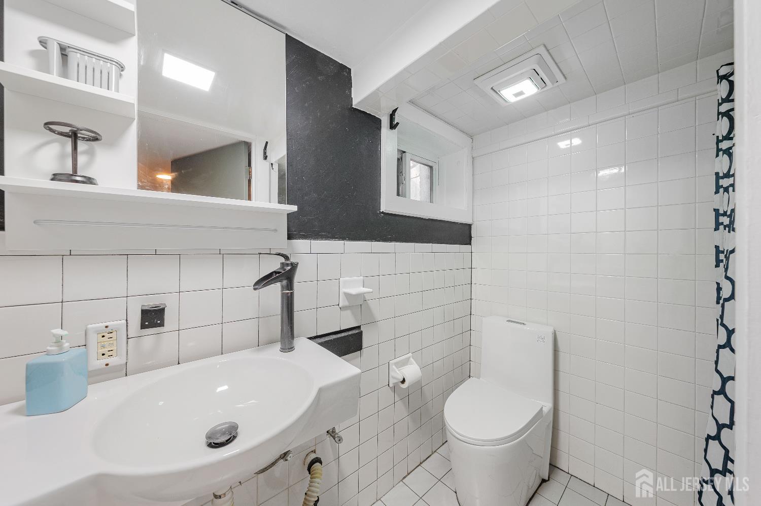 631 Union Avenue Elizabeth, NJ 07208 - Photo 21 of 30 a bathroom with a sink a toilet and a mirror