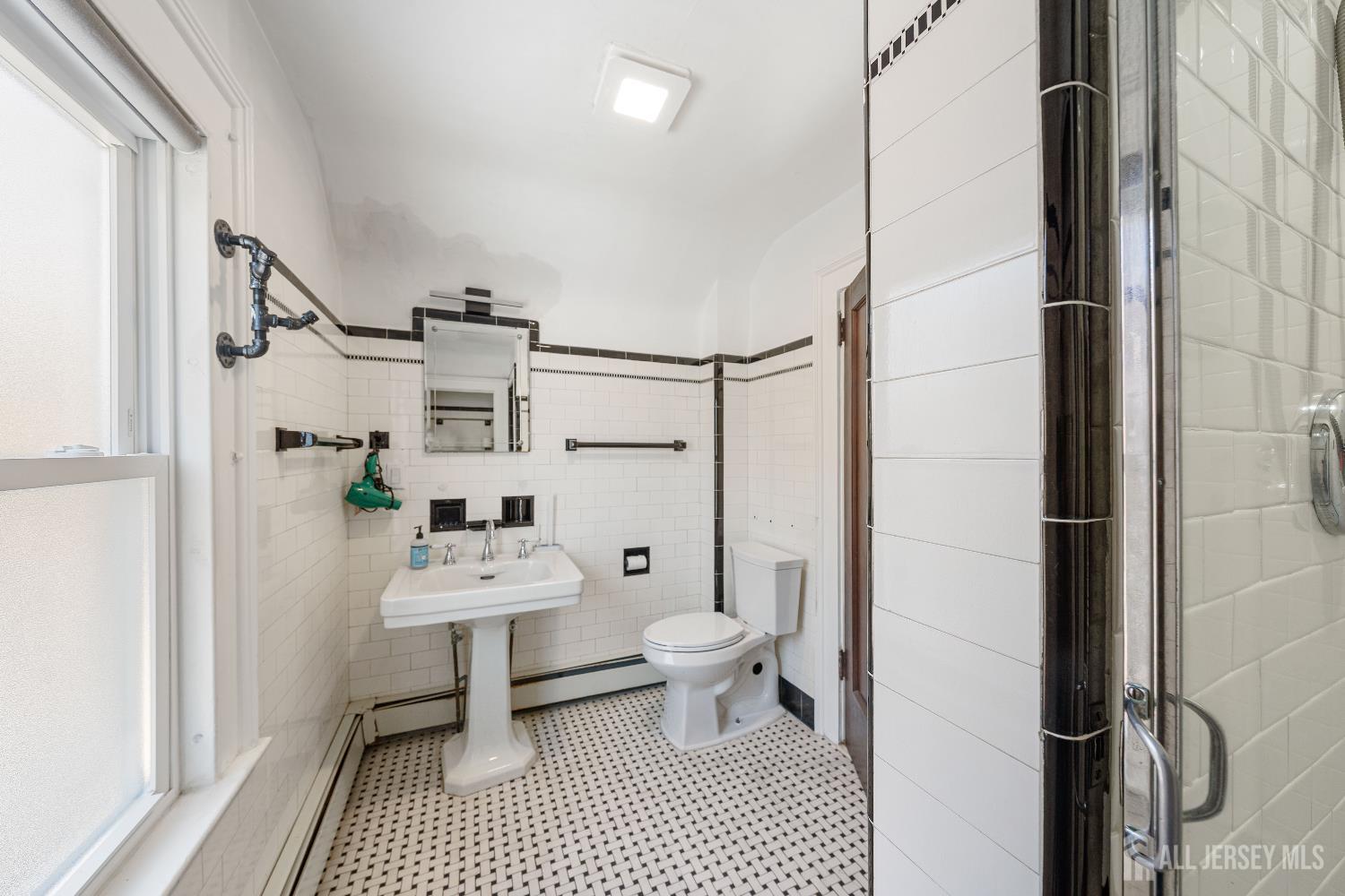 631 Union Avenue Elizabeth, NJ 07208 - Photo 7 of 30 a bathroom with a sink toilet vanity and shower