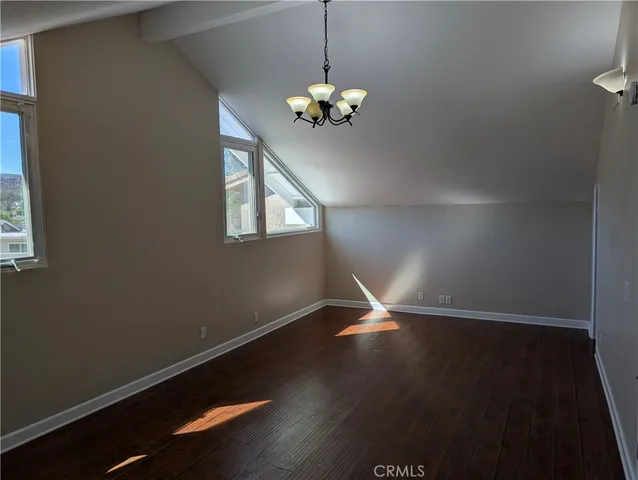 a view of wooden floor and chandelier in a room