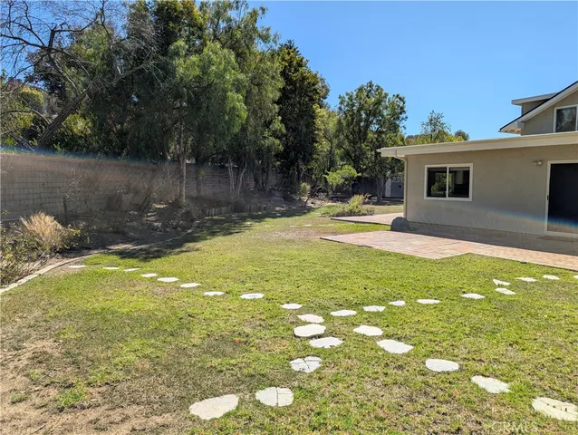 a swimming pool with trees in the background