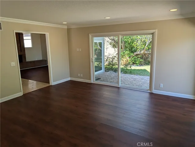 a view of a room with wooden floor and garden