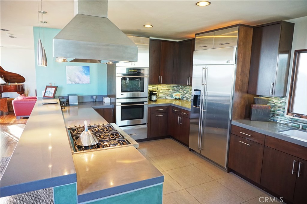 3211 Vista Drive Manhattan Beach, CA 90266 - Photo 3 of 35 a kitchen with stainless steel appliances granite countertop a stove refrigerator and cabinets