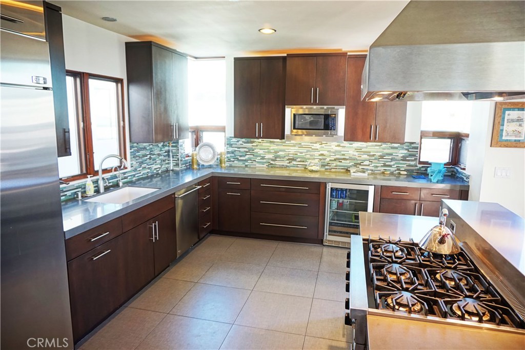 3211 Vista Drive Manhattan Beach, CA 90266 - Photo 5 of 35 a kitchen with stainless steel appliances granite countertop wooden cabinets and sink