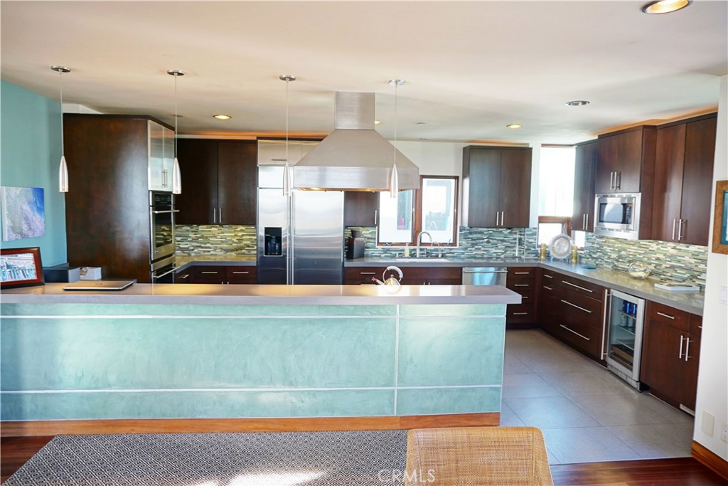 3211 Vista Drive Manhattan Beach, CA 90266 - Photo 6 of 35 a large kitchen with kitchen island a large counter top stainless steel appliances and cabinets