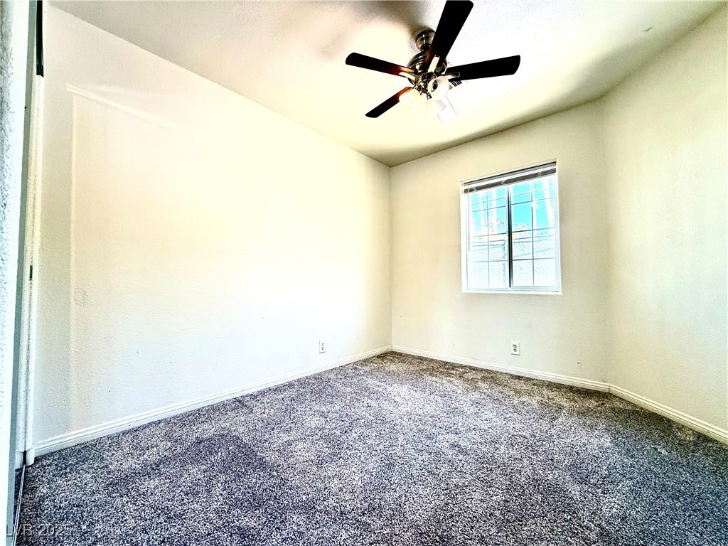 764 Benedict Drive Las Vegas, NV 89110 - Photo 15 of 30 Carpeted spare room with baseboards and ceiling fa