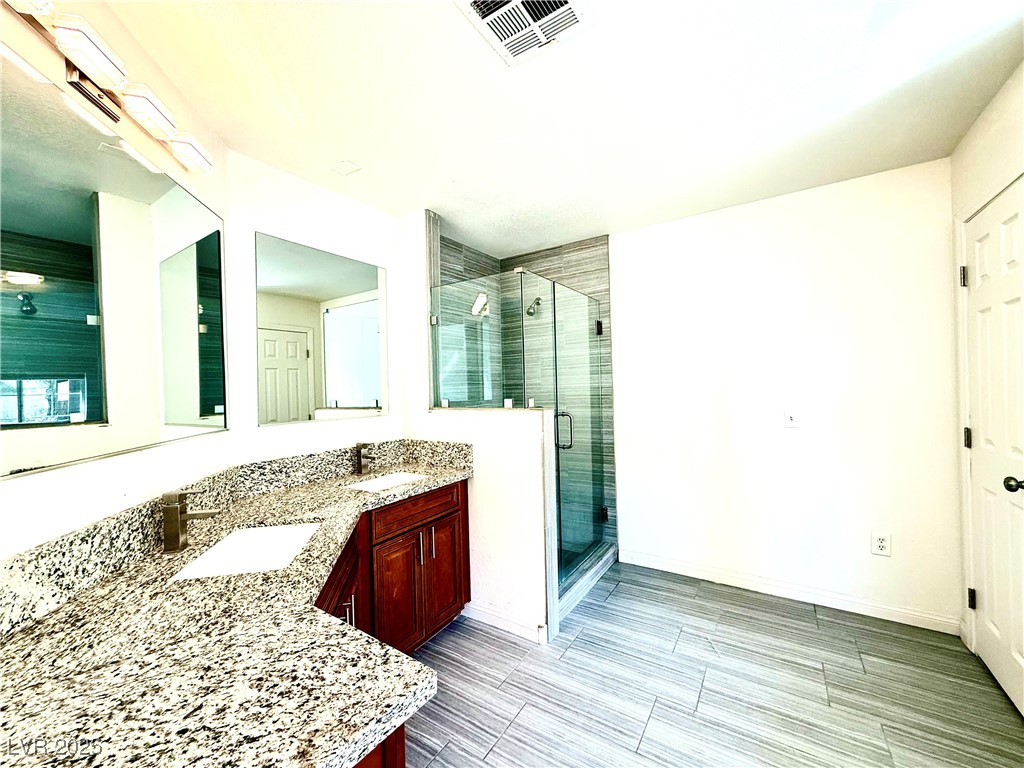 764 Benedict Drive Las Vegas, NV 89110 - Photo 20 of 30 Bathroom with a shower stall, double vanity, visib